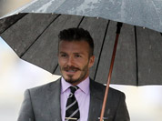 Former England football captain David Beckham attends a hand over Olympic Flame ceremony at the Panathenaean stadium in Athens.