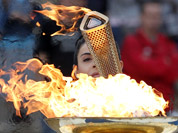Actress Ino Menegaki, dressed as a high priestess, lights the torch at a ceremony in Panathinean stadium in Athens. The torch begins its 70-day journey to arrive at the opening ceremony of the London 2012 Olympics, from the Greek capital.