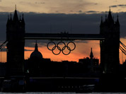 The Olympic rings hang from the Tower Bridge after sunset, as London prepares for the 2012 Summer Olympics. 