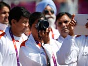 Members of the Indian Olympic team take photos during the Olympic Team Welcome Ceremony at the Athletes` Village at the Olympic Park.