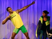 Fans look at the new wax model of Jamaican sprinter Usain Bolt, at a photocall for its launch at the Madame Tussauds wax museum, ahead of the 2012 Summer Olympics.