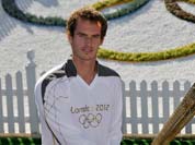 Scottish tennis player Andy Murray, hands over the Olympic flame to US tennis player Venus Williams at the All England Tennis Club in Wimbledon, ahead of the 2012 Summer Olympics.