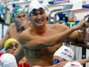 Michael Phelps, shares a laugh with other US swimming team members during a training session at the Aquatics Center at the Olympic Park, in London.