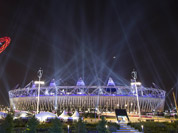 Searchlights shine over the Olympic Stadium during a rehearsal for the opening ceremony at the 2012 Summer Olympics in London.