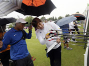 South Korea`s Im Dong-hyun, right, inspects his arrows on the target next to Taiwan`s Kuo Cheng-Wei, in blue, during an individual ranking round at the 2012 Summer Olympics in London.