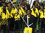 Jamaica`s Usain Bolt carries the flag during the Opening Ceremony at the 2012 Summer Olympics in London.