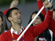 Serbia`s Novak Djokovic carries the flag during the Opening Ceremony at the 2012 Summer Olympics in London.