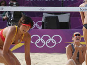 Zhang Xi, from China looks on as Anastasia Vasina, from Russia celebrates with her teammate Anna Vozakova, winning a point during their Beach Volleyball match at the 2012 Summer Olympics.