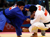 Hiroaki Hiraoka of Japan competes against Ashley McKenzie of Great Britain (in blue) during the elimination round of the men`s 60kg judo competition at the 2012 Summer Olympics.