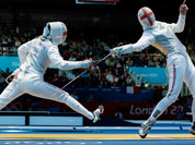 Natalia Sheppard of Great Britain, left and Sophie Troiano of Great Britain compete in the of round 64 during women`s fencing at the 2012 Summer Olympics in London.