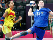 Victoria Zhilinskayte of Russia, center, takes a shot at goal as Angola`s Nair Almeida, left, and Natalia Bernardo, right, watch during their women`s handball preliminary match at the 2012 Summer Olympics.