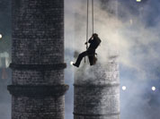 An artist is lowered down during the Opening Ceremony at the 2012 Summer Olympics in London.