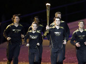 Torchbearers run during the Opening Ceremony at the 2012 Summer Olympics in London. 