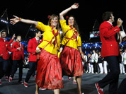 Athletes from Spain wave to spectators as they parade during the Opening Ceremony at the 2012 Summer Olympics in London. 