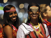 Fardouza Moussa Eguen of Djibouti smiles as she walks with her team to the Olympic Stadium for the Opening Ceremony of the 2012 Summer Olympics in London. 