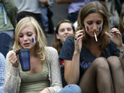 People gather at Trafalgar Square in downtown London to watch the clock countdown prior to the Opening Ceremony of the 2012 Summer Olympics in London. 