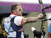 Britain`s Laurence Godfrey aims for the target as India`s Jayanta Talukdar watches during a individual ranking round at the 2012 Summer Olympics in London.