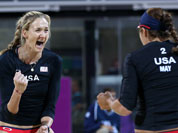 Misty May-Treanor, right, and Kerri Walsh, left, of US celebrate winning a point against Australia in their Beach Volleyball match at the 2012 Summer Olympics in London.