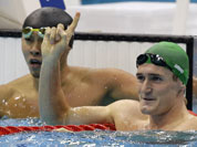 South Africa`s Cameron van der Burgh waves as Japan`s Kosuke Kitajima looks on after their men`s 100 meters breaststroke semifinal at the Aquatics Centre in the Olympic Park during the 2012 Summer Olympics in London.