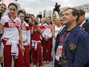Russian Prime Minister Dmitry Medvedev, right, speaks with Russian Olympics team members during his visits to Olympic village at the 2012 Summer Olympics, in London.