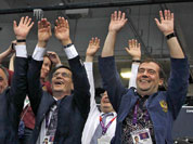 Russian Prime Minister Dmitry Medvedev, right, Deputy Prime Minister and Russia`s Olympic Committee president Alexander Zhukov, center, and Sports Minister Vitaly Mutko, left, react during a women`s preliminary volleyball match between Britain and Russia at the 2012 Summer Olympics, in London.