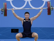 Italy`s Mirco Scarantino lifts during the men`s 56-kg, group B, weightlifting competition at the 2012 Summer Olympics in London.