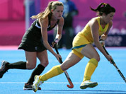 Australia`s Anna Flanagan, right, and New Zealand`s Samantha Harrison, vie for the ball during their preliminary round women`s field hockey match at the 2012 Summer Olympics in London. 