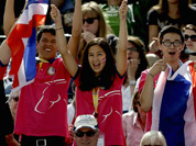 Fans cheer as Nina Lamsan Ligon, of Thailand, and her horse Butts Leon, compete in the equestrian eventing dressage phase at the 2012 Summer Olympics in London. 