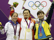 Gold medalist, China`s Guo Wenjun celebrates with silver medalist, France`s Celine Goberville and bronze medalist Olena Kostevych of Ukraine following the final in the women`s 10-meter air pistol event at the 2012 Summer Olympics in London.