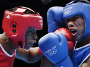 Wellington Arias Romero of the Dominican Republic lands a punch against Colombia`s Eduar Marriaga Campo during men`s light 60-kg boxing at the 2012 Summer Olympics in London.