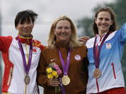 Gold medalist Kimberley Rhode of the United States of America, celebrates with silver medalist, China`s Wei Ning, and bronze medalist Danka Bartekova of Slovakia, following the final in the woman`s skeet event at the 2012 Summer Olympics in London.