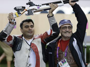 Gagan Narang,  celebrates winning the bronze medal in the men`s 10-meter air rifle, with his coach Stanislav Lapidus, at the 2012 Summer Olympics in London. 