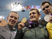 United States` Brendan Hansen, left, South Africa`s Cameron van der Burgh, center, and Australia`s Christian Sprenger pose with their medals for the men`s 100-meter breaststroke swimming final at the Aquatics Centre in the Olympic Park during the 2012 Summer Olympics.