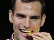 Hungray`s fencer Aron Szilagyi celebrates winning the gold medal in the men`s individual sabre at the ExCel Centre, at the 2012 Summer Olympics.