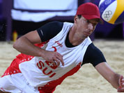 Jefferson Bellaguarda from Switzerland dives for a ball during the Beach Volleyball match against Italy at the 2012 Summer Olympics.