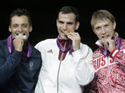 Gold medalist Hungary`s Aron Szilagy, center, stands with silver medalist Italy`s Diego Occhiuzzi, left, and bronze medalist Russia`s Nikolay Kovalev, right, on the medal stand after the men`s fencing individual sabre gold medal match at the 2012 Summer Olympics.