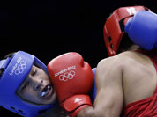 Kazakhstan`s Danabek Suzhanov fights India`s Vijender, right, during a middle weight 75-kg preliminary boxing match at the 2012 Summer Olympics.