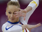 The hand of Romania`s gymnast Sandra Raluca Izbasa show calluses as she performs on the floor during the Artistic Gymnastics women`s qualification at the 2012 Summer Olympics.