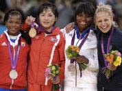Silver medalist Acosta Bermoy, of Cuba, from left, gold medalist An Kum Ae, of North Korea and bronze medalists Priscilla Gneto, of France and Rosalba Forciniti, of Italy, share the podium after the women`s 52-kg judo competition at the 2012 Summer Olympics.