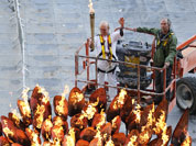 Torchbearer Austin Playfoot, top center, poses after lighting the Olympic cauldron at the Olympic Stadium during the 2012 Summer Olympics.