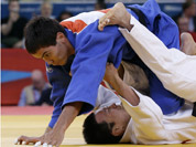 Ki Chun Wang of South Korea competes with Rinat Ibragimov of Kazakhstan, top, during the men`s 73-kg judo competition at the 2012 Summer Olympics in London.