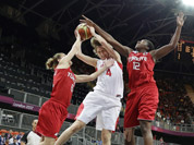 Czech Republic`s Jana Vesela (4) is defended by Czech Republic`s Katerina Bartonova (6) and Republic`s Lenka Bartakova (12) during the first half of a preliminary women`s basketball game at the 2012 Summer Olympics in London. 