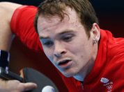 Paul Drinkhall of Great Britain serves against Dimitrij Ovtcharov of Germany during their men`s table tennis match at the 2012 Summer Olympics in London. 
