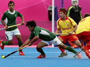 Pakistan`s Waseem Ahmad, and Spain`s David Alegre vie for the ball during their men`s field hockey preliminary-round match at the 2012 Summer Olympics in London.