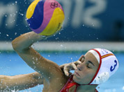 Ma Huanhuan of China, attempts to block a shot by Anna Espar Llaquet of Spain during their women`s water polo preliminary round match at the 2012 Summer Olympics in London.