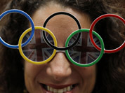 Dana Kerstein wears glasses with the Olympic rings as she attends the archery competition at the 2012 Summer Olympics in London.