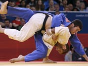 Travis Stevens of the United States competes with Avtandil Tchrikishvili of Georgia, top, during the men`s 81-kg judo competition at the 2012 Summer Olympics.