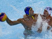 Peter Biros, right, of Hungary defends against Mladan Janovic of Montenegro during a preliminary men`s water polo match at the 2012 Summer Olympics.