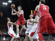 Russia`s Andrei Kirilenko (15) shoots between China`s Wang Zhizhi, left, and China`s Yi Jianlian, right, during the first half of a preliminary en`s basketball game at the 2012 Summer Olympics in London.