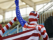 Fans dressed in costumes in the colors of the U S flag watch swimming competitions at the Aquatics Centre in the Olympic Park during the 2012 Summer Olympics in London.